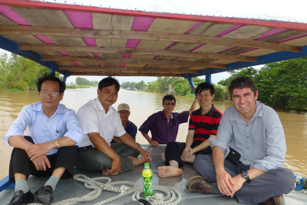 Professor Tom Cochrane (far right) next to former PhD student Thanh Duc Dang